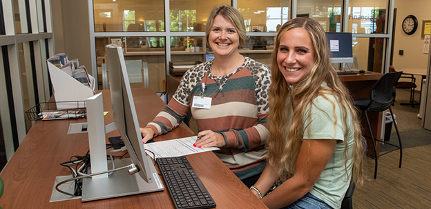 Student with instructor at computer